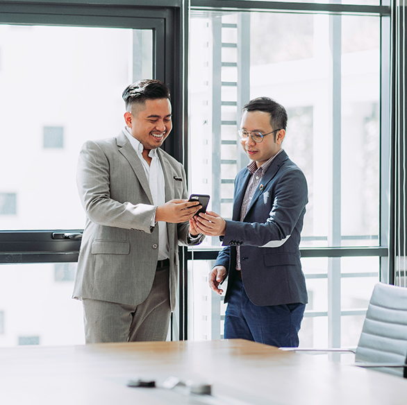 two CPA professionals looking at cell phone