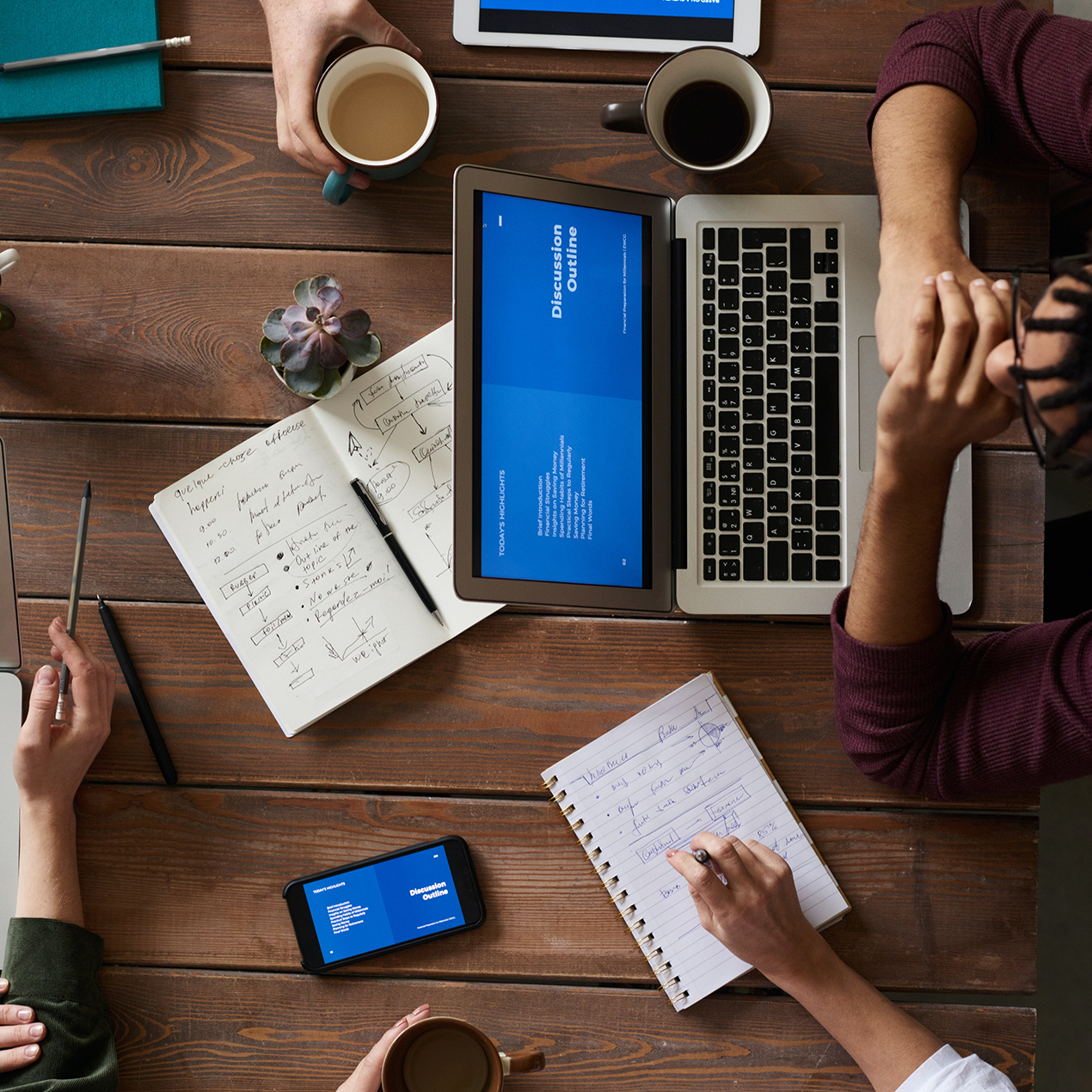 overhead view of accountants working at a desk