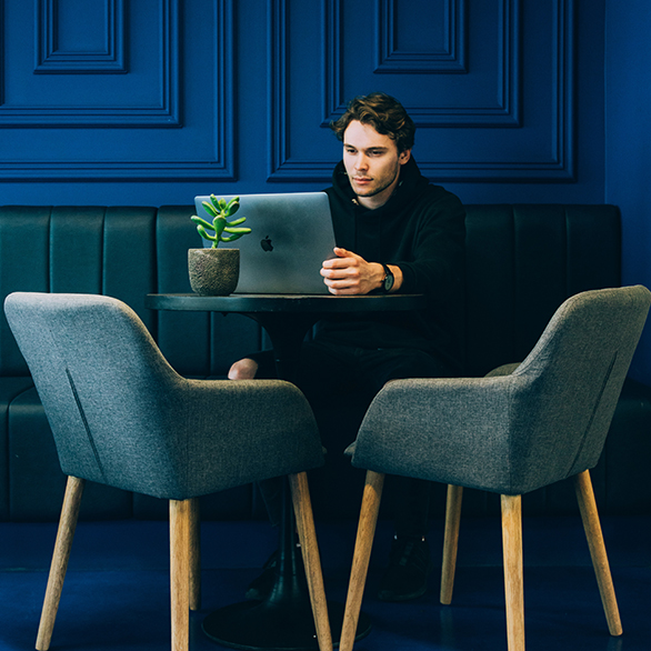 certified public accountant sitting in front of a laptop at a coffee shop